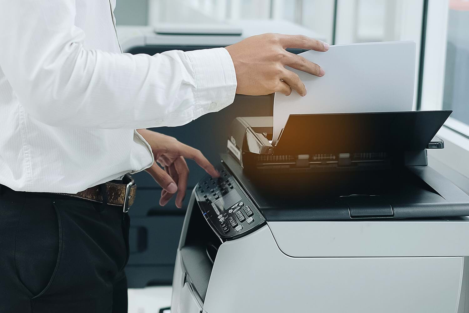 Close Up of Businessman Putting Paper into an Office Printer